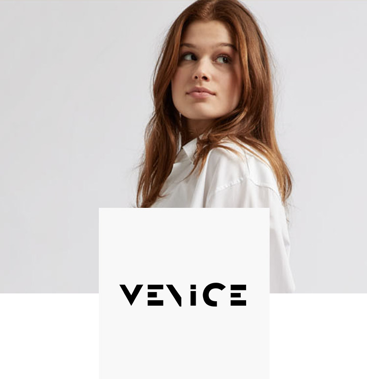 Woman with red hair in white shirt models for venice